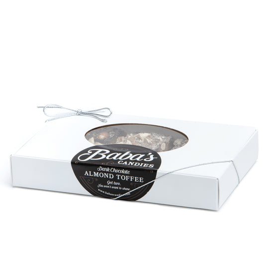 A box of dark chocolate almond toffee with a transparent window, labeled 'Baba's Candies'.